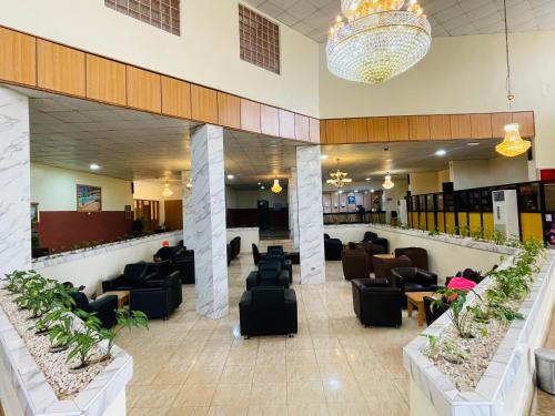 a lobby of a hospital with couches and chairs at Royalbirds Hotel & Towers in Akure