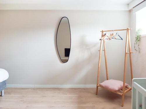 a mirror on the wall of a room with a chair at Charming house in city centre Oud-Beijerland in Oud-Beijerland