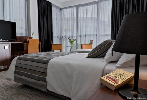 a hotel room with a bed and a television at Priska Med Luxury Rooms in Split