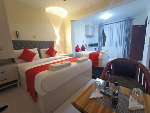 a hotel room with two beds and a table at Bijou Hotel in Nairobi