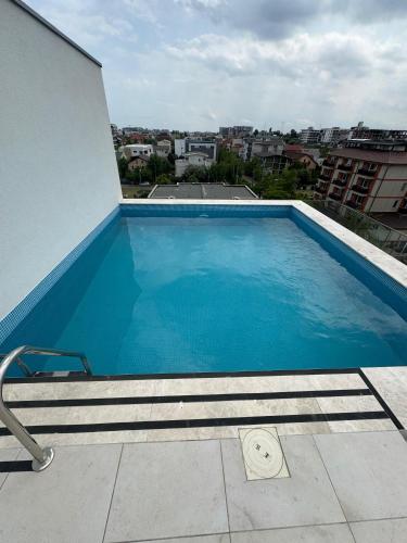 a large blue swimming pool on top of a building at Olivia Apartament in Năvodari