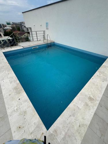a large blue swimming pool on top of a building at Olivia Apartament in Năvodari
