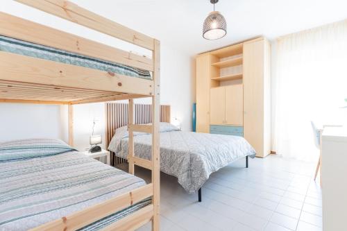 Postel nebo postele na pokoji v ubytování Residence CARAVELLA 2