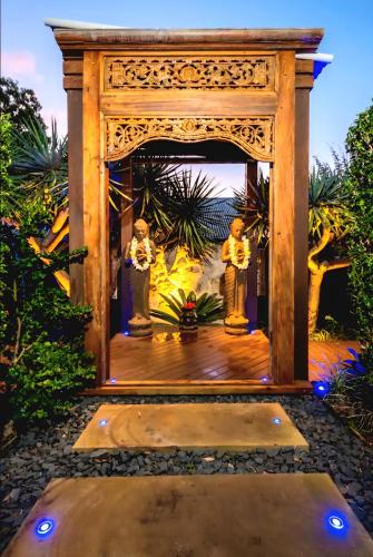 a gazebo with two statues on it at Tranquil Balinese Retreat in a resort style oasis in Gold Coast