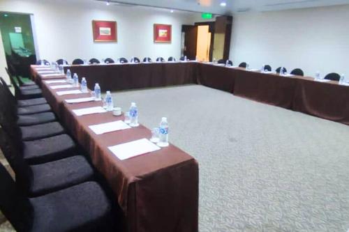 a row of tables in a room with chairs at Hotel Shangri-la Kota Kinabalu in Kota Kinabalu