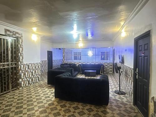 a living room with couches and a table in a room at Daniel's Hotel & Apartment in Mama