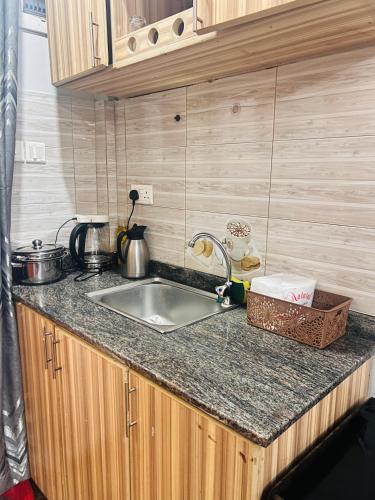 a kitchen with a sink and a counter top at Cozy loft in Kampala