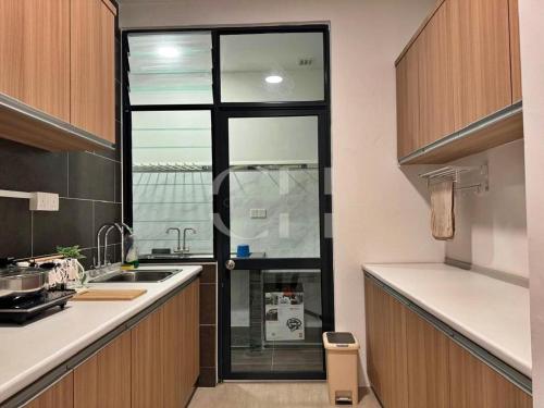 a kitchen with a sink and a window in it at Rex apartment Kuching 3 pax in Kuching