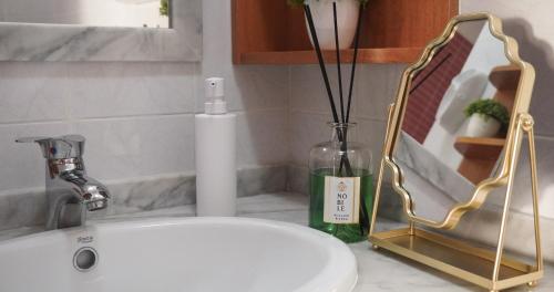a sink with a vase and a bottle on a counter at Al Bastione B&B in Barletta