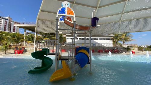 a water park with a water slide in the water at Piazza DiRoma com acesso ao Acqua Park todos os dias in Caldas Novas