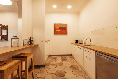 a kitchen with white cabinets and a sink at Art Hotel Roma in Liepāja