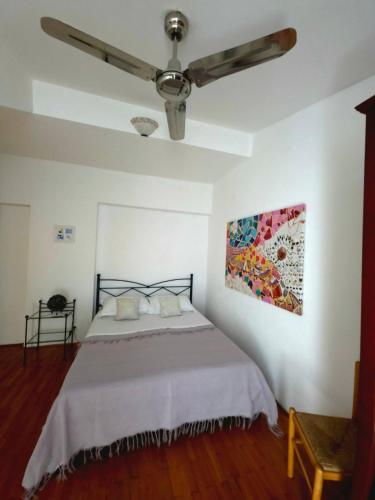 a bedroom with a bed with a ceiling fan at Villa Sandra Hvar in Hvar