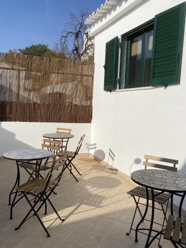 a group of tables and chairs on a patio at Refúgio No16 Ocean Air & Rooftop Flair in Albufeira