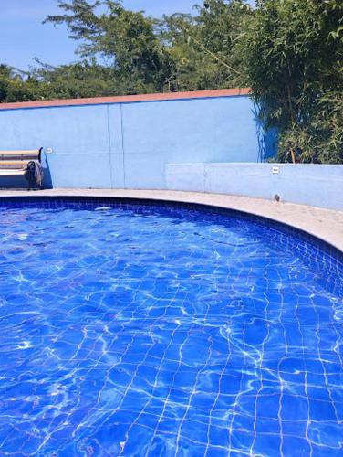 a blue swimming pool with a bench next to it at Royalpark resort in Jāmb