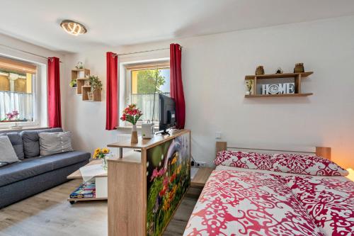 a living room with a bed and a couch at Ferienwohnung Marks - Hohnstein in Rathewalde