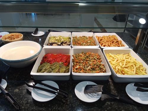 a table with four trays of different types of food at Leflet Sanlucar in Sanlúcar la Mayor