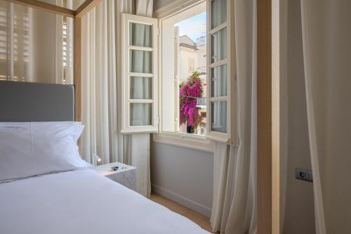 Ένα ή περισσότερα κρεβάτια σε δωμάτιο στο Amalie Suites