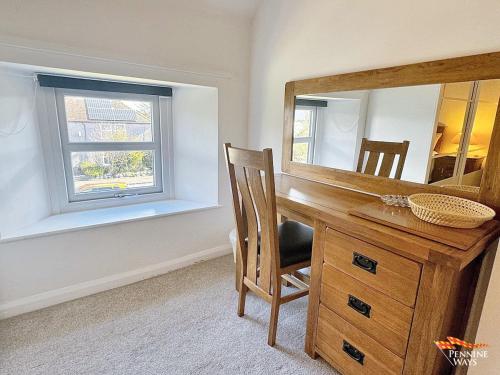 a room with a desk with a mirror and a chair at 14 Pennine Road, Halton-Lea-Gate in Coanwood