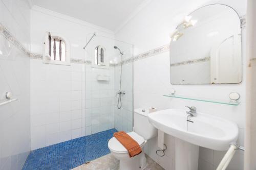 a white bathroom with a sink and a toilet at Villa Alisa in Tías