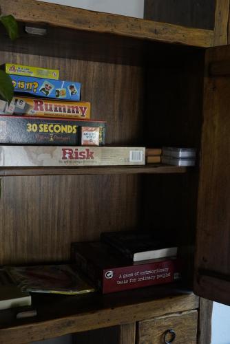a wooden book shelf with some books on it at Holiday appartment Casa del Cervo in Sestola