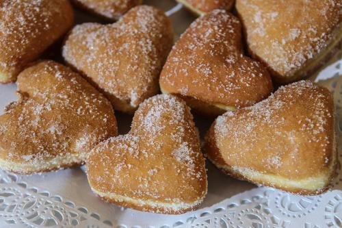 a pile of sugar covered donuts on a plate at Best Western JFK Hotel in Naples