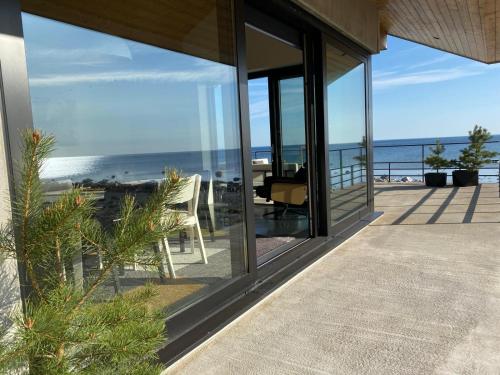 a view of the ocean from the balcony of a house at Seaside Rendezvous in Kalana