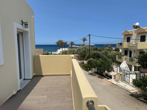a balcony of a building with a view of the ocean at Zephyros Village Maisonettes in Karpathos Town