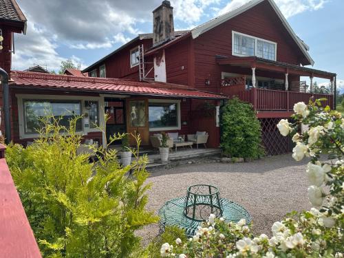a red house with a bench in front of it at Bruntegården in Rättvik