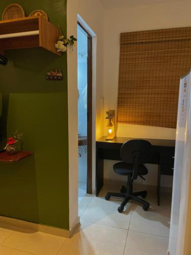 a office with a desk and a chair in a room at Residencial Temporada Aracaju in Aracaju