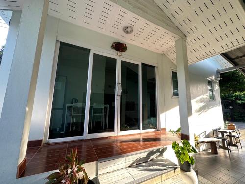 a screened in porch of a house with sliding glass doors at K house in Ban Bang Khen (1)