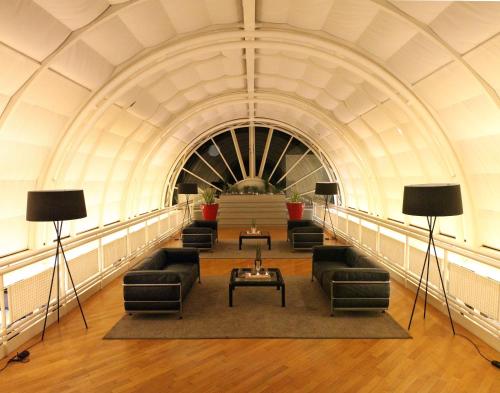 a hallway with couches and tables in a building at Mec Paestum Hotel in Paestum