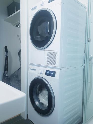 a washing machine and a dryer in a room at GRANDE SUITE with kitchen dish washer, dryer washer in Zürich