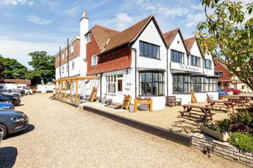 a large white building with benches in front of it at The Kensington in Great Yarmouth
