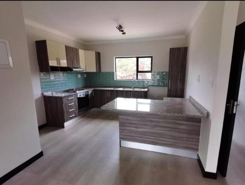 a large kitchen with a large island in the middle at Letsleep 