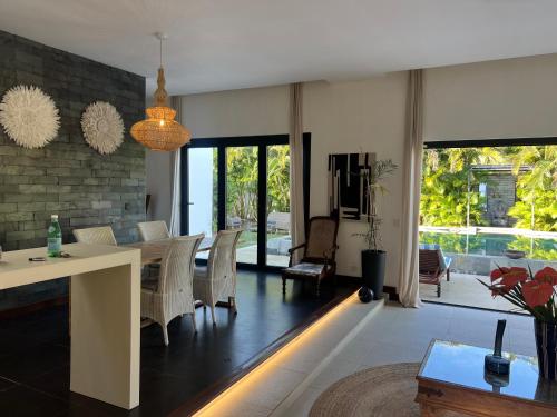 a living room with a dining table with a led light at Blue Palm Villa with Private Pool & Tropical Garden in Cap Malheureux