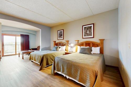 a hotel room with two beds and a balcony at Chula Vista Condo 2344 and 2346 in Wisconsin Dells