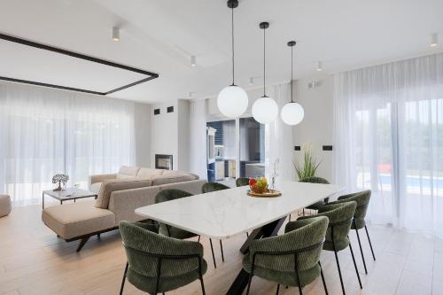 a dining room with a white table and chairs at Villa dell Re in Žminj