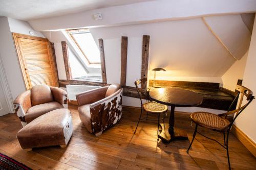 a living room with a table and chairs at RHUBARB at Drapers Hall in Shrewsbury