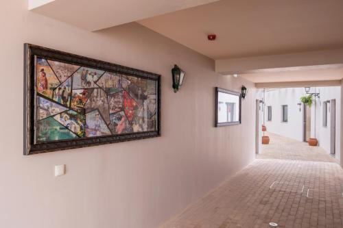 a large painting on a wall in a hallway at Vila Galé Casas d'Elvas - Historic Hotel in Elvas