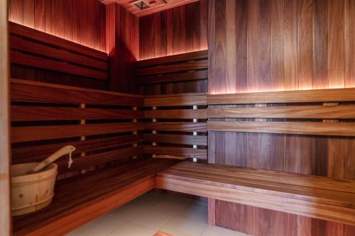 a sauna with wooden walls and a bath tub at Hotel Unicus Palace Old Town - Destigo Hotels in Kraków