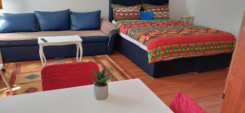a living room with a couch and a bed at Brand New Central Apartments in Sarajevo