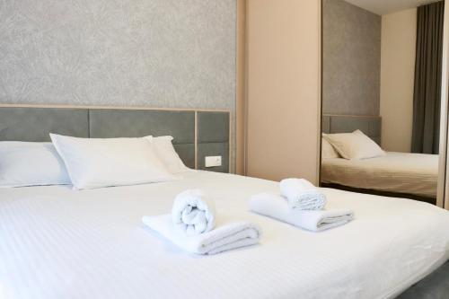 a hotel room with two towels on a bed at The Royal Nest Sarajevo Waves in Sarajevo