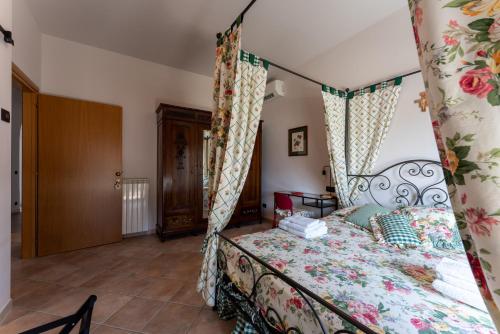 a bedroom with a bed with a canopy at Tenuta Tre Gemme in Cantina- Renascenzia SantIrene in Catignano