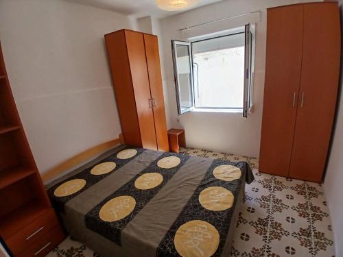 a small bedroom with a bed and a window at Nino Lux Apartments Ulcinj in Ulcinj