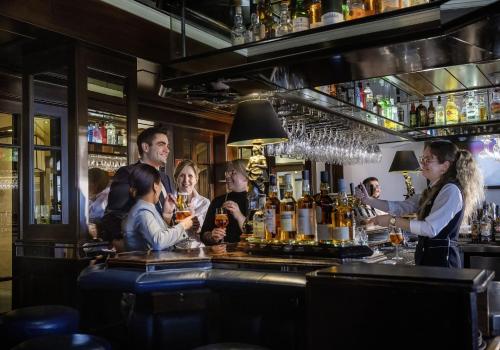 a group of people sitting at a bar at Maritim Hotel Darmstadt in Darmstadt