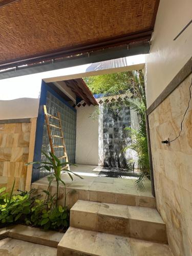 a stairway leading to a building with a ladder at Dejaviews Resort in Singaraja