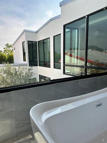 a white bath tub in front of a house at Modern ZEN Vibe 3BR Pool Villa Phuket in Ban Tha Khreng