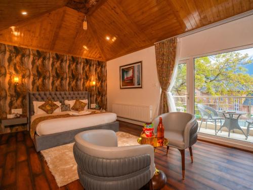 a bedroom with a bed and a living room at Moustache Hostel Pahalgam in Pahalgām