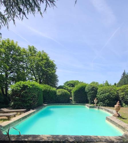 une grande piscine bleue dans un jardin dans l'établissement Studio - Le Sainte-Victoire, à Aix-en-Provence