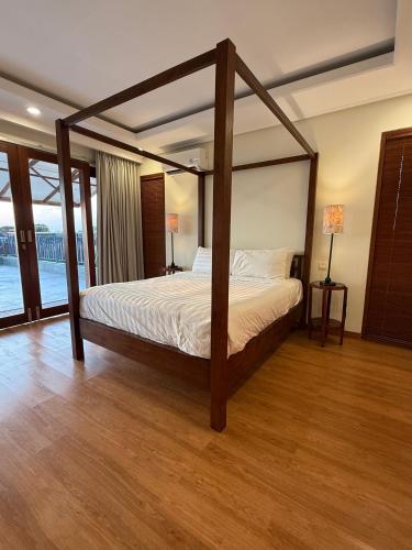 a bedroom with a canopy bed in a room at Avela bali villa in Kerobokan